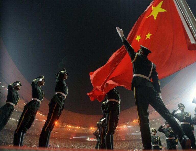 **FILE** In this Aug. 8, 2008 file photo, Chinese military soldiers salute as the Chinese flag is raised during the Opening Ceremony for the Beijing 2008 Olympic Games in Beijing, China. China said Tuesday, Jan. 20, 2009, that its overall security situation had improved over the past year, although it remained alert to separatism in Tibet and Xinjiang and firmly opposed to U.S. arms sales to Taiwan. (AP Photo/Matt Dunham, File)