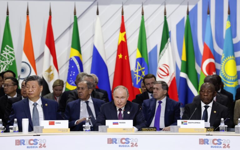 epa11679400 Officials, including South Africa's President Cyril Ramaphosa (R), Russian President Vladimir Putin (C) and China's President Xi Jinping (L), attend a plenary session in the outreach/BRICS Plus format at the BRICS summit in Kazan, Russia, 24 October 2024. The BRICS summit takes place from 22 to 24 October. EPA/MAXIM SHEMETOV / POOL