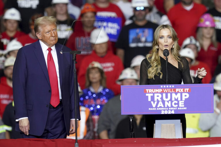 Republican presidential nominee former President Donald Trump listens as Megyn Kelly speaks at a campaign rally at PPG Paints Arena, Monday, Nov. 4, 2024, in Pittsburgh. (AP Photo/Matt Freed)