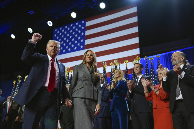 Republican presidential nominee former President Donald Trump gestures as he walks with former first lady Melania Trump at an election night watch party at the Palm Beach Convention Center, Wednesday, Nov. 6, 2024, in West Palm Beach, Fla. (AP Photo/Evan Vucci).Donald Trump