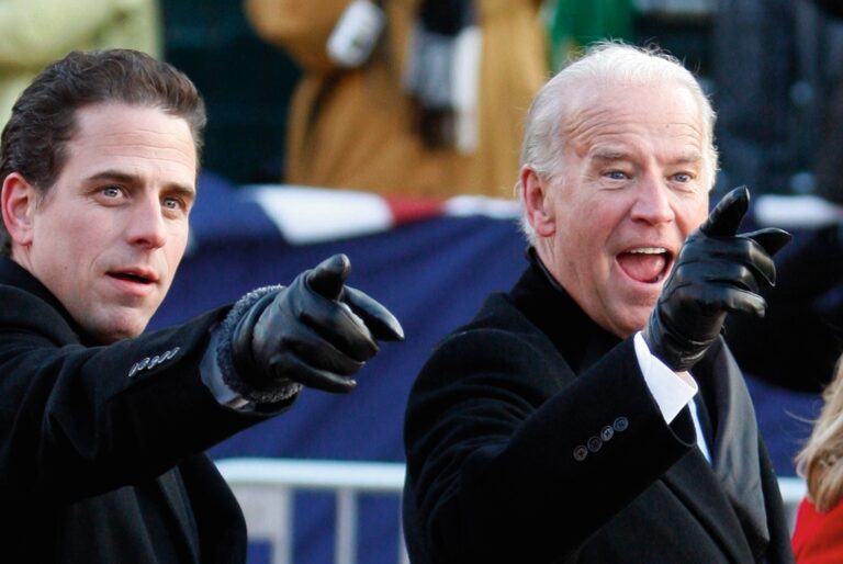 U.S. Vice President Biden and son Hunter gesture as they walk down Pennsylvania Avenue
