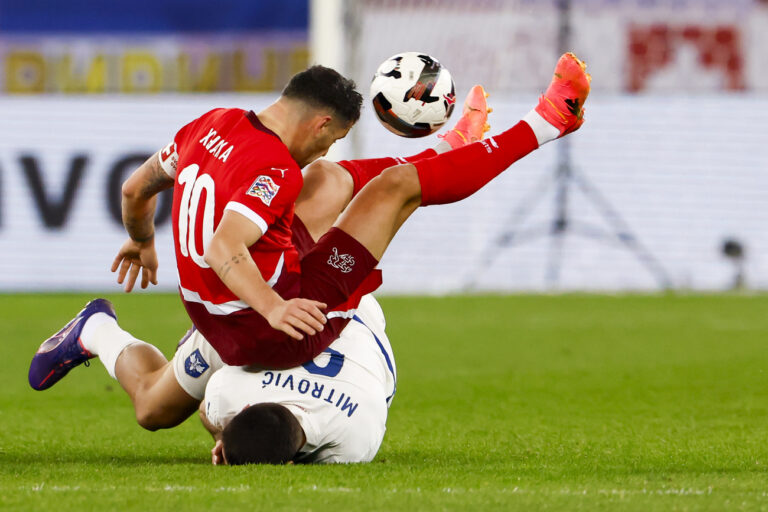 Switzerland's midfielder Granit Xhaka, left, fights for the ball with Serbia's Aleksandar Mitrovic, right, during the UEFA Nations League soccer match between Switzerland and Serbia at the Letzigrund stadium in Zurich, Switzerland on Friday, November 15, 2024. (KEYSTONE/Michael Buholzer)