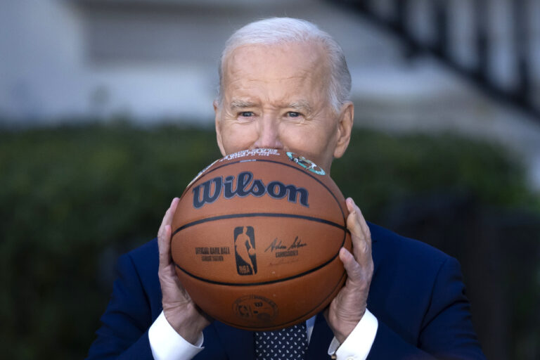 President Joe Biden throws a basketball he received from the Boston Celtics at an event to celebrate the team's victory in the 2024 National Basketball Association Championship, on the South Lawn of the White House in Washington, Thursday, Nov. 21, 2024. (AP Photo/Ben Curtis)