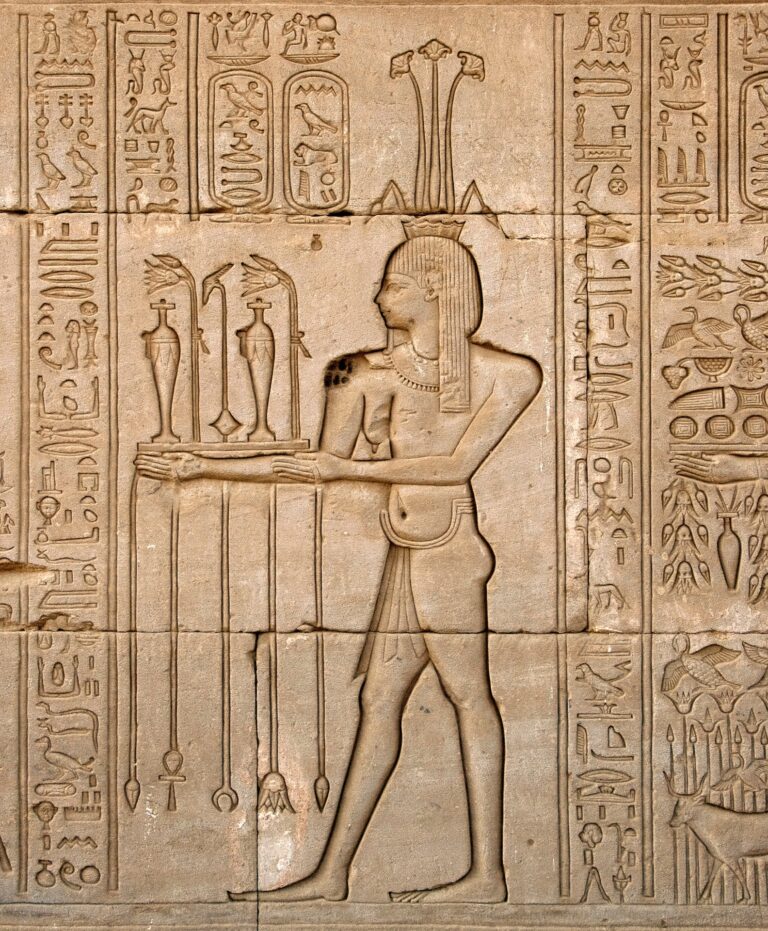 Ancient Egyptian sunken relief depicting the god of Nile, Hapy, and hieroglyphs