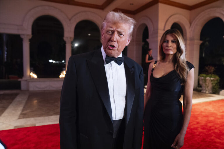 Melania Trump looks on as President-elect Donald Trump speaks to reporters before a New Year's Eve party at Mar-a-Lago, Tuesday, Dec. 31, 2024, in Palm Beach, Fla. (AP Photo/Evan Vucci).Donald Trump,Melania Trump