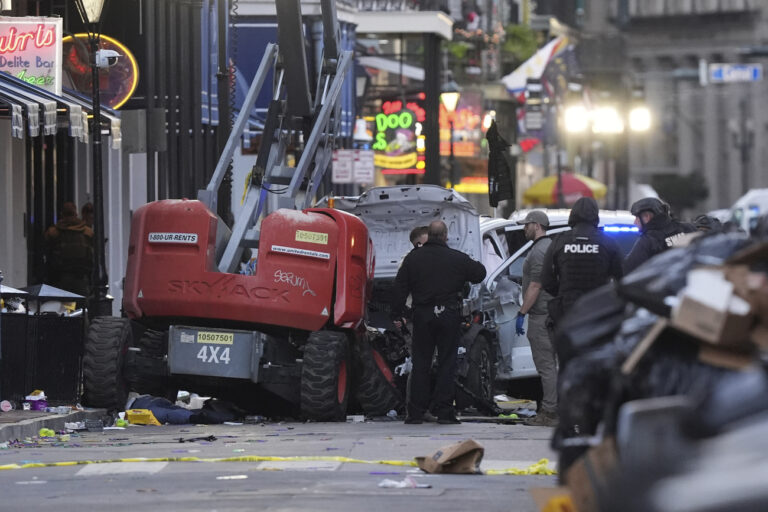 EDS NOTE: GRAPHIC CONTENT - Emergency personnel work the scene on Bourbon Street after a vehicle drove into a crowd on New Orleans' Canal and Bourbon Street, Wednesday Jan. 1, 2025. (AP Photo/Gerald Herbert)