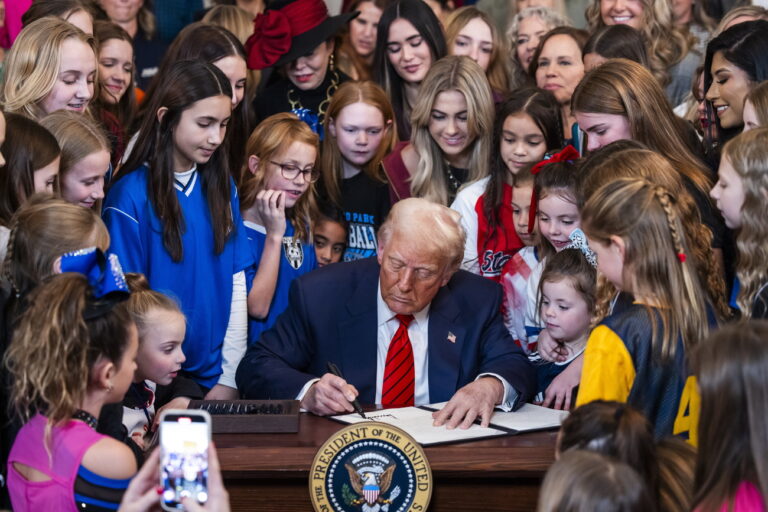 epa11877761 US President Donald Trump (C), surrounded by young female athletes, signs an executive order banning transgender athletes from women's sports, in the East Room of the White House in Washington, DC, USA, 05 February 2025. President Trump called the order titled 'Keeping Men Out of Women's Sports, a 'common sense'. EPA/JIM LO SCALZO