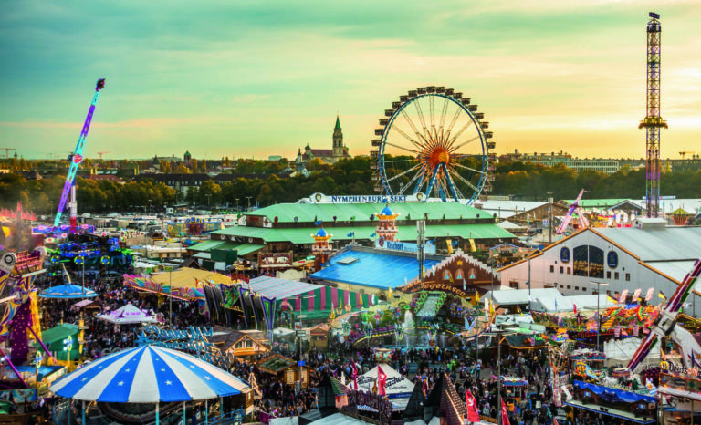 Munich, Germany - October 7: people and fairground rides at the biggest folk festival in the world - the oktoberfest on oktober 7, 2018 in munich.; Shutterstock ID 1217379883; purchase_order: -; job: -; client: -; other: -