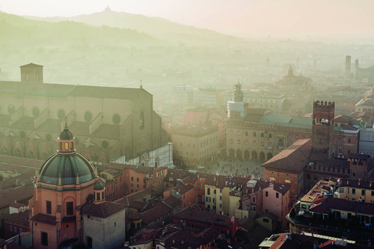 Bologna, high angle view of city and buildings at sunset, San Petronio and Piazza Maggiore on left side. Emilia Romagna, italy